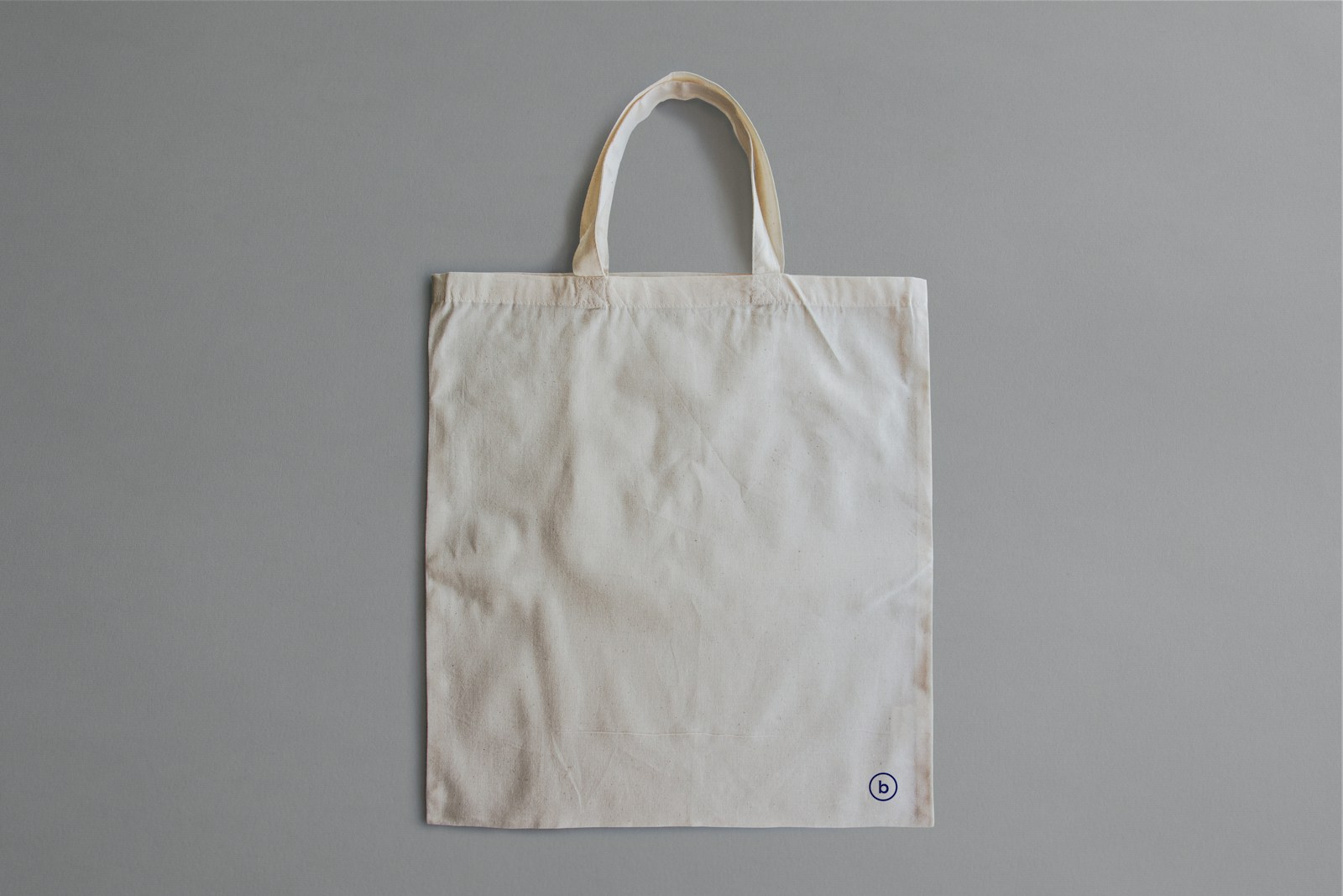 white reusable bag on gray surface
